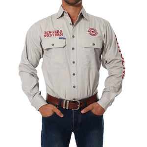 A person wearing the Ringers Western Hawkeye Embroidered Shirt, a light gray long-sleeve button-up work shirt with red "Ringers Western" text and logo, two front pockets, UPF50+ protection, and made from 100% cotton. They also have on blue jeans and a brown belt.