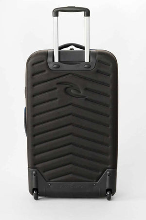 The Rip Curl F-Light Global Search Ref 100L Travel Bag is black with a hard-shell exterior, telescopic handle, two wheels, diagonal ridges on the front, and a central stylized wave logo.