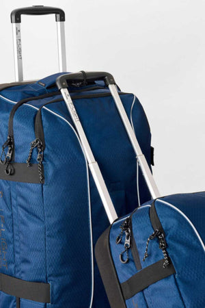 Two blue Rip Curl F-Light Global Search Ref 100L Travel Bags with extended silver handles, black straps, and zipper pulls are placed side by side against a plain white background.