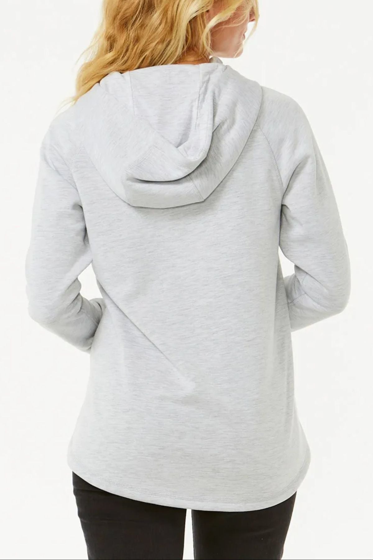 A person with long blonde hair is seen from behind wearing a light gray Rip Curl Anti Series Flux III Jacket, hood down and hands in pockets, standing against a plain white background.