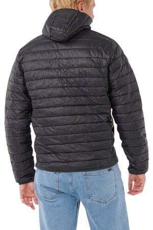 A person is shown from the back wearing the Rip Curl Anti Series Search Puffer Hood in black with a hood and light blue jeans, standing against a white background.