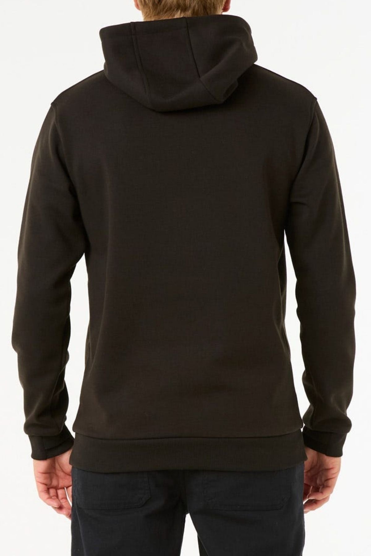A person is facing away from the camera, wearing a plain black Rip Curl Anti Series Search Base Hood and black pants against a white background.
