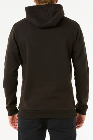 A person is facing away from the camera, wearing a plain black Rip Curl Anti Series Search Base Hood and black pants against a white background.