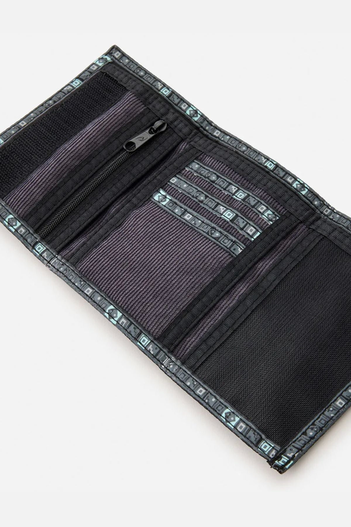 The Rip Curl Archive Cord Surf Wallet is an open black and gray wallet with multiple card slots, a zippered pocket, a bill section, and patterned trim along the edges.
