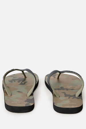A pair of Rip Curl Camo Bloom Thongs with green and brown camouflage-patterned BLOOM algae foam soles and dark green straps is shown from the back against a white background, highlighting their comfortable fit.