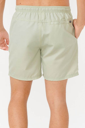 A person wearing light green Rip Curl Bondi Volley shorts with their back facing the camera. Made from recycled PET, these shorts feature an elastic waistband and a small back pocket, blending style with sustainability.