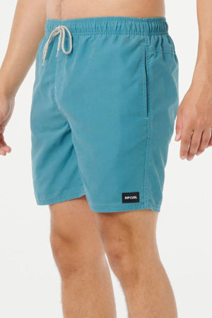 A person models teal Rip Curl Bondi Volley swim shorts made from recycled PET, featuring an elastic waistband and white drawstring, against a plain white background.