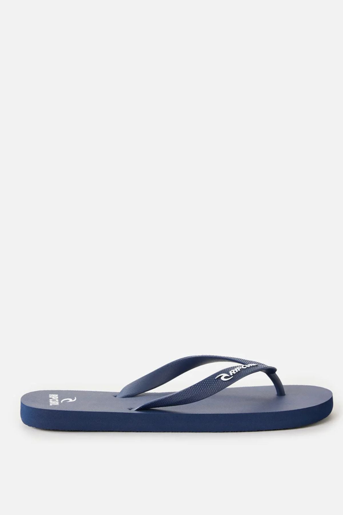 A single Rip Curl Brand Logo Bloom Thong in navy blue, made with algae-blended foam and matching straps, is displayed in side profile against a plain light background.