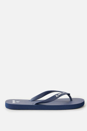 A single Rip Curl Brand Logo Bloom Thong in navy blue, made with algae-blended foam and matching straps, is displayed in side profile against a plain light background.