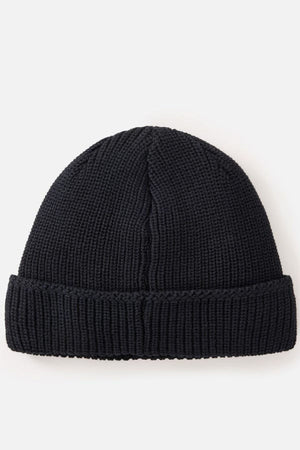 The Rip Curl Classic Surf Lined Reg Beanie, in black with a folded brim, is perfect for outdoor adventures and is shown against a plain white background.