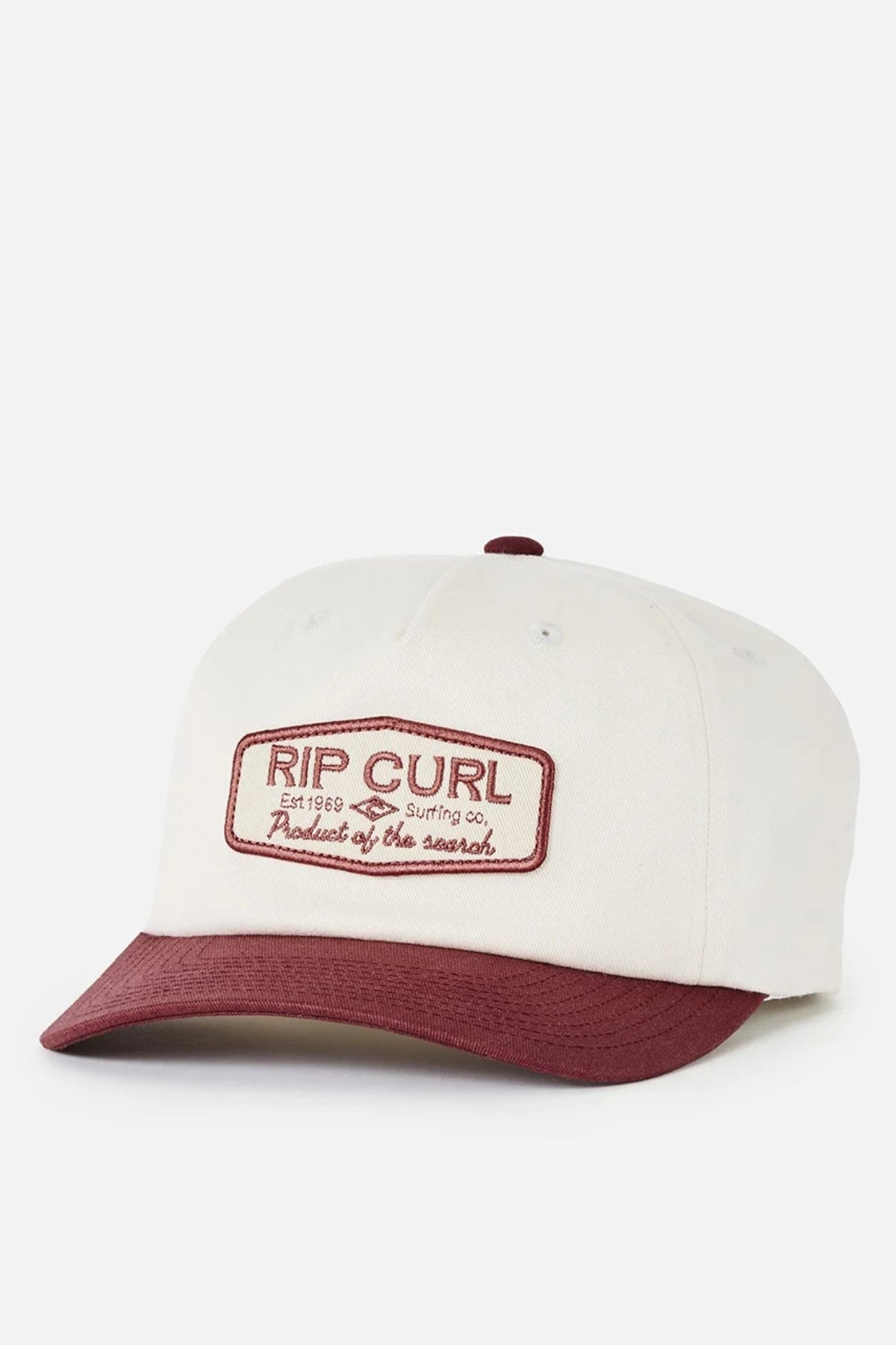 The Rip Curl Classic Surf SB Cap is a white cotton snapback hat featuring a maroon brim and a maroon embroidered patch on the front that reads “RIP CURL Surfing Co. Product of the Search,” capturing timeless surf culture style.