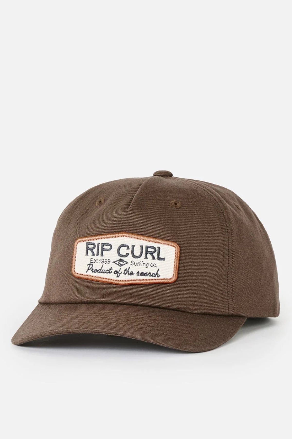 The Rip Curl Classic Surf SB Cap is a brown cotton snapback featuring a curved brim and a rectangular patch on the front that reads “RIP CURL Surfing Co. Product of the search” in black and brown text, shown against a plain white background.