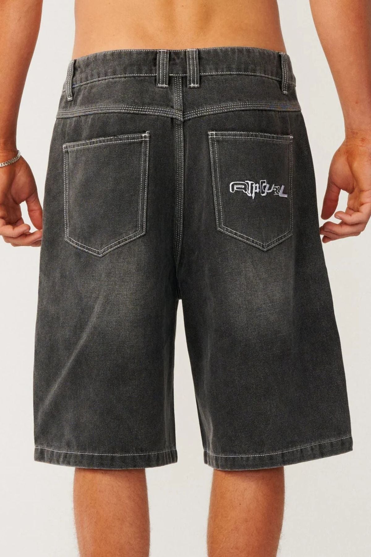 Back view of relaxed baggy Rip Curl Archive Dirty Denim Walkie Walkshort in black with white contrast stitching and an embroidered logo on the back right pocket.
