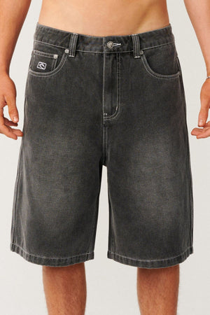 Rip Curl Archive Dirty Denim Walkie Walkshort, featuring relaxed baggy black denim with white contrast stitching and a small logo patch on the front pocket.