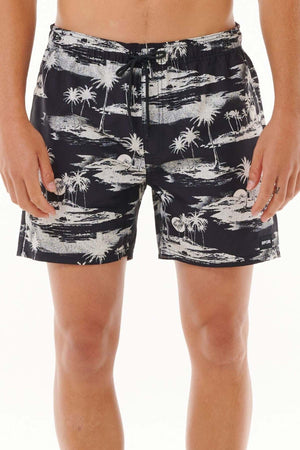 A person modeling the Rip Curl Dreamers Volley, black board shorts featuring an all-over print of white palm tree patterns. The image is cropped to highlight the shorts, crafted from recycled fabric, and upper legs against a plain white background.