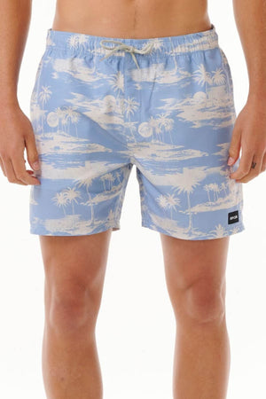 A person wears the Rip Curl Dreamers Volley swim shorts, which feature a stylish light blue color adorned with a white tropical island pattern. Made from recycled rip suede fabric, these board shorts include an elastic waistband and display a small black label on the left leg against a clean white background.