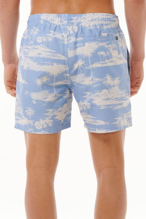 A person wearing the stylish Rip Curl Dreamers Volley board shorts, featuring a light blue color with a white tropical palm tree and island print. Made from recycled rip suede fabric, these shorts stand out against the plain white background.