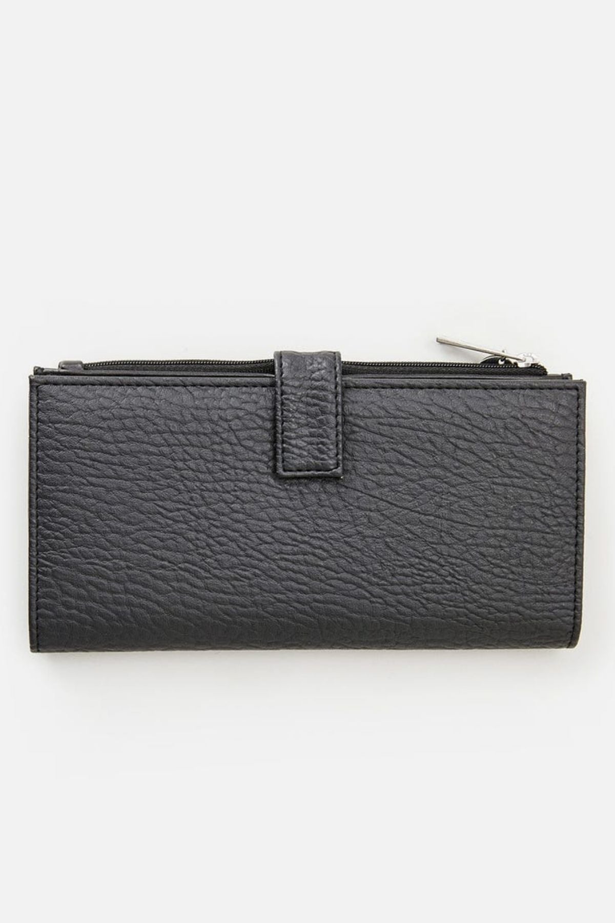 The Rip Curl Essentials II Phone Wallet is a sleek black accessory made from textured leather, featuring a zipper closure and flap. Its rectangular shape elegantly lies flat against a white background, drawing attention to the handy mobile phone pocket tucked inside, with the zipper pull prominently visible at the top right corner.