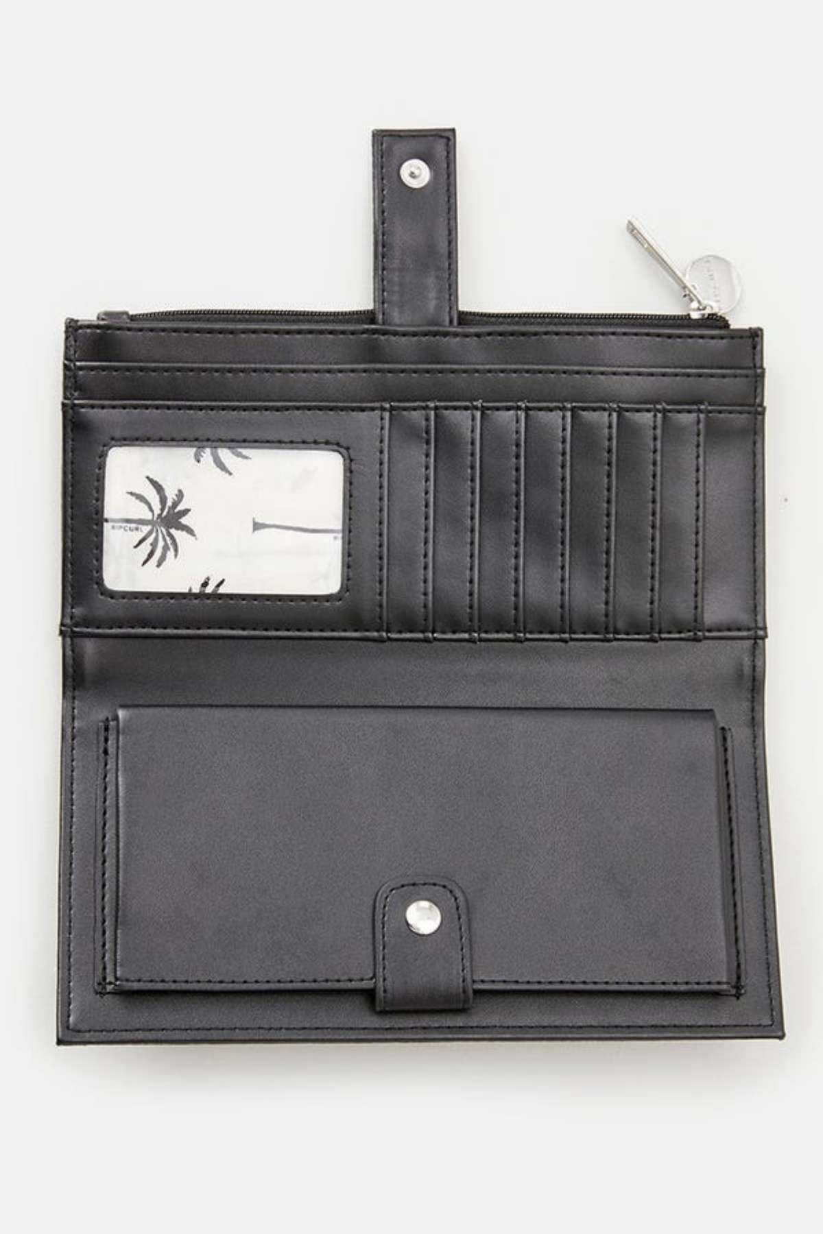 The Rip Curl Essentials II Phone Wallet is a stylish black accessory featuring multiple card slots and a transparent ID window adorned with a leaf pattern. It includes a button closure, an open design revealing a zipped compartment at the top, and a section for bills below, delivering both style and functionality in one sleek package.