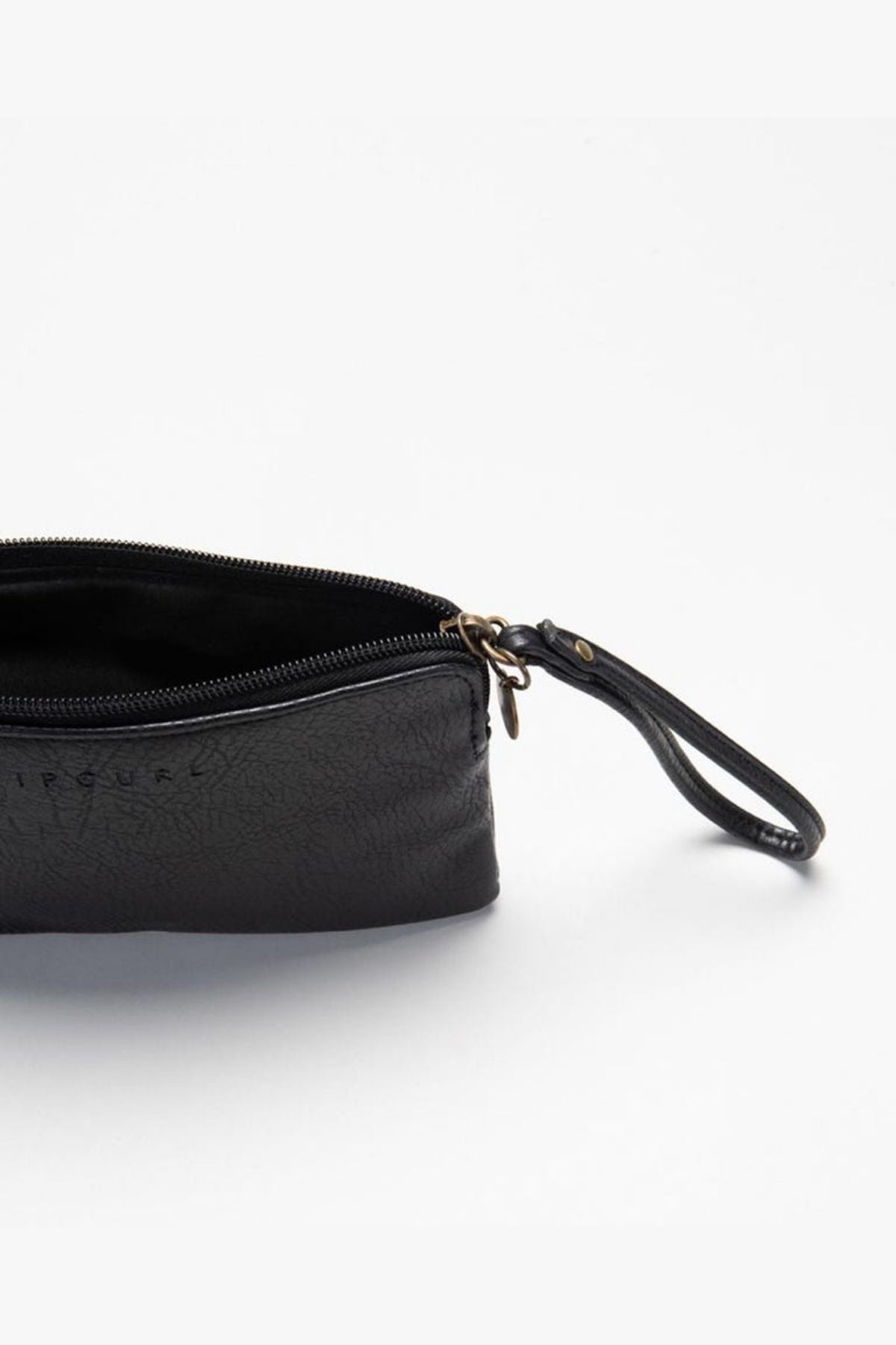 The Rip Curl Essentials 2 Wristlet, a black textured pouch crafted from faux leather, features an open zipper and a small leather strap attached to one end. The interior is lined in black, and an embossed logo enhances its elegance.