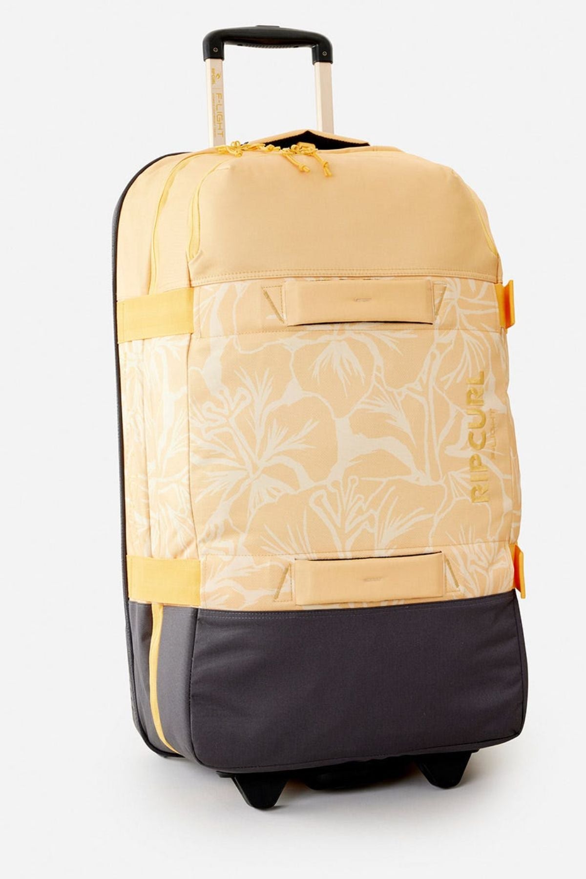 The Rip Curl F-Light Global 100L Tropics Travel Bag features a yellow and gray floral design, black wheels, lockable zips, telescopic handle, side handles, recycled polyester build, and "Rip Curl" printed in yellow on the front.