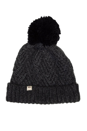 The Rip Curl Groundswell Pom Pom Beanie is a knitted dark gray hat with a textured chevron design, a prominent contrasting pom-pom on top, and a small front tag.