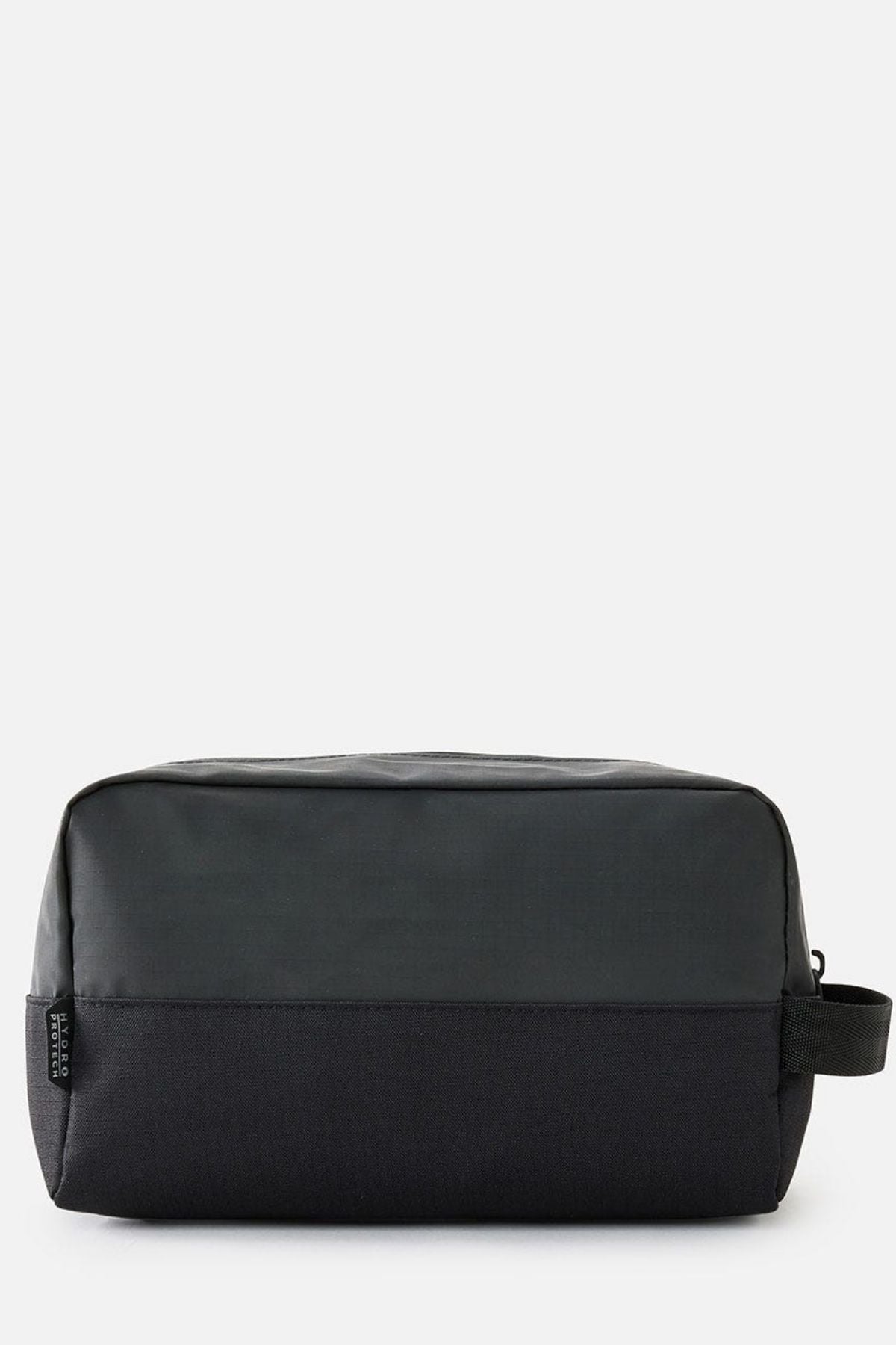The Rip Curl Icons Groom Toiletry Bag is a rectangular black toiletry bag with a subtle texture, featuring a top zipper and a small side handle, making it perfect for travel organization. Its minimalist design is striking against the plain light gray background.