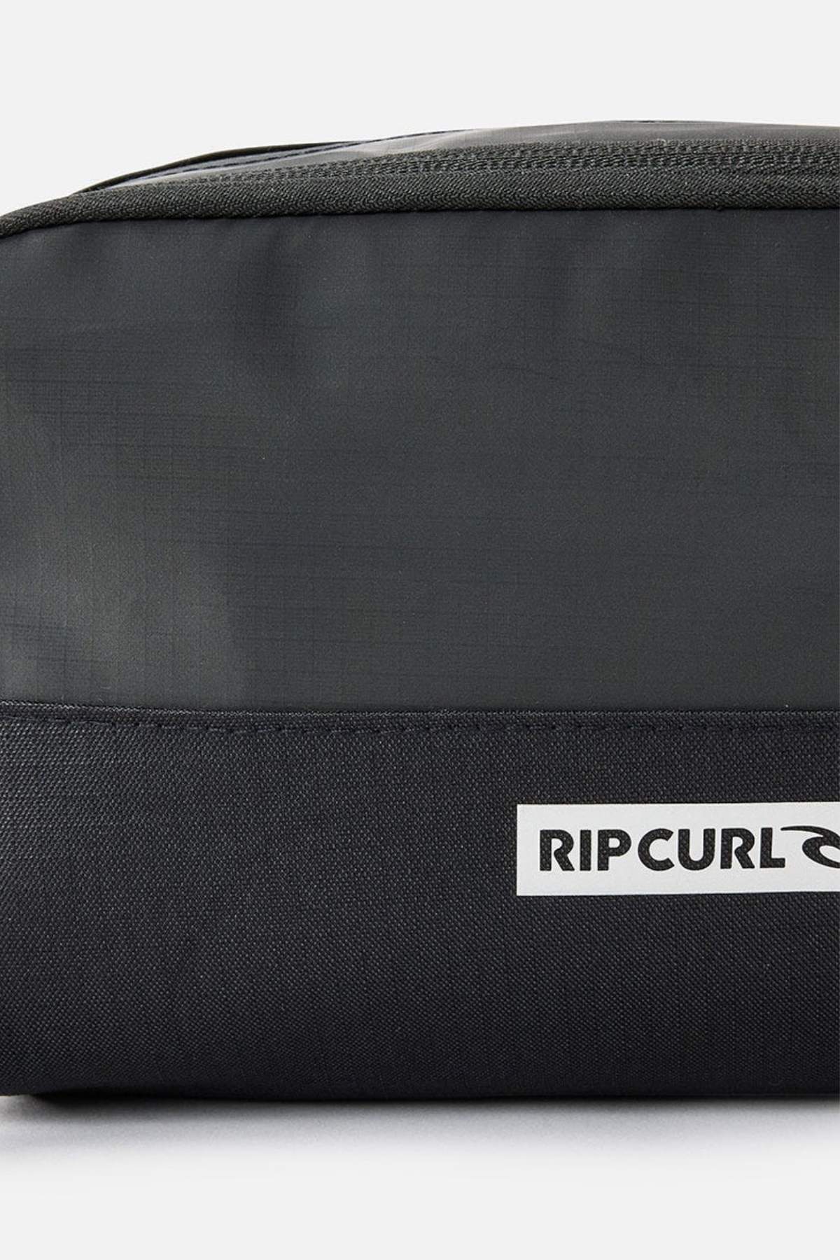 Close-up of the green and black Rip Curl Icons Groom Toiletry Bag, ideal for travel. The prominent logo on the lower black section complements its durable fabric and minimalist design, making it easy to keep your essentials organized.