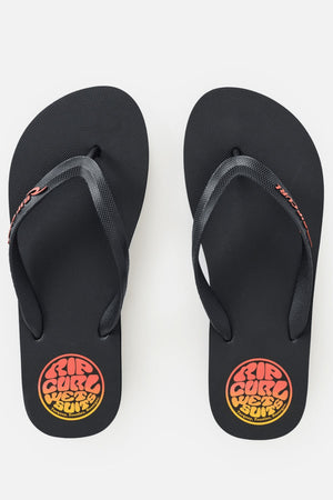 A pair of Rip Curl Icons Of Surf Bloom Open Toe Sandals in black, featuring “RIP CURL WETSUIT” in orange and yellow on the insoles. The dark straps display a red “RIP CURL” logo on each side and are crafted with eco-friendly BLOOM algae foam for enhanced comfort and sustainability.