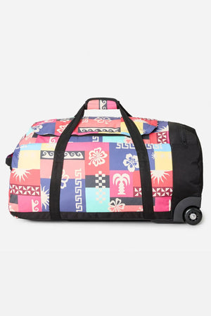 The Rip Curl Jupiter 80L Mixed Travel Bag features black handles and wheels, a vibrant patchwork of tropical and geometric prints, and is made from recycled polyester for stylish, sustainable travel.