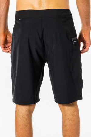A person is shown from the back wearing Rip Curl Mirage Core Boardshorts in black, featuring a small zippered pocket on the right side. The background is plain white.