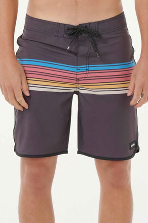A person wearing Rip Curl Mirage Surf Revival 19" Boardshorts with horizontal blue, pink, orange, and yellow stripes. Made from recycled PET, these quick-drying shorts feature a drawstring waist and a logo patch near the hem.