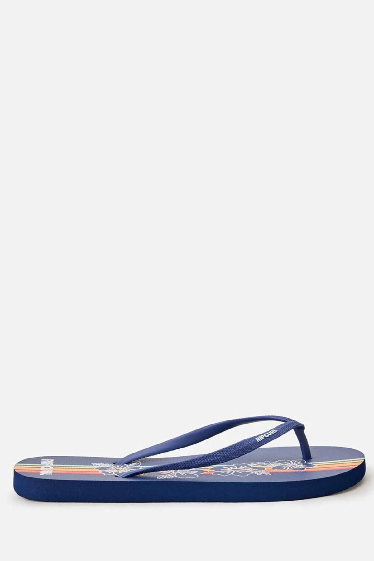The Rip Curl Mixed Bloom Thongs are comfy flip flops made with algae-blended foam EVA, shown in a side profile with thin straps and a floral-patterned footbed against a plain white background.