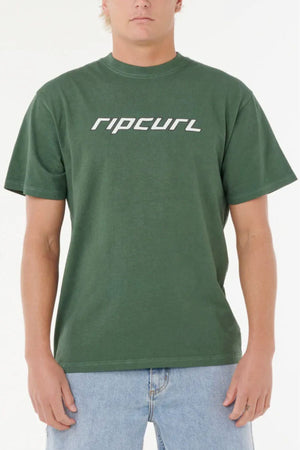 A person wearing a dark green Rip Curl Nu Dosed Tee with light blue jeans stands against a plain white background.