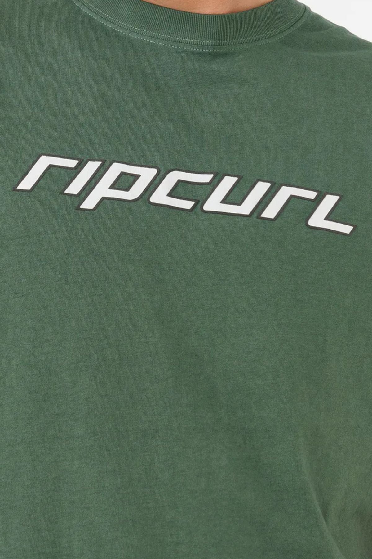 A close-up of the Rip Curl Nu Dosed Tee—a green, cotton jersey t-shirt with "ripcurl" printed boldly in stylized white letters across the chest.
