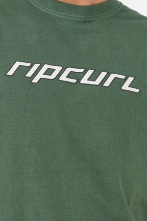 A close-up of the Rip Curl Nu Dosed Tee—a green, cotton jersey t-shirt with "ripcurl" printed boldly in stylized white letters across the chest.