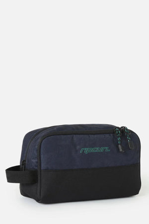 Navy and black Rip Curl Archive Groom Toiletry Bag with a side handle and green logo text on the front.