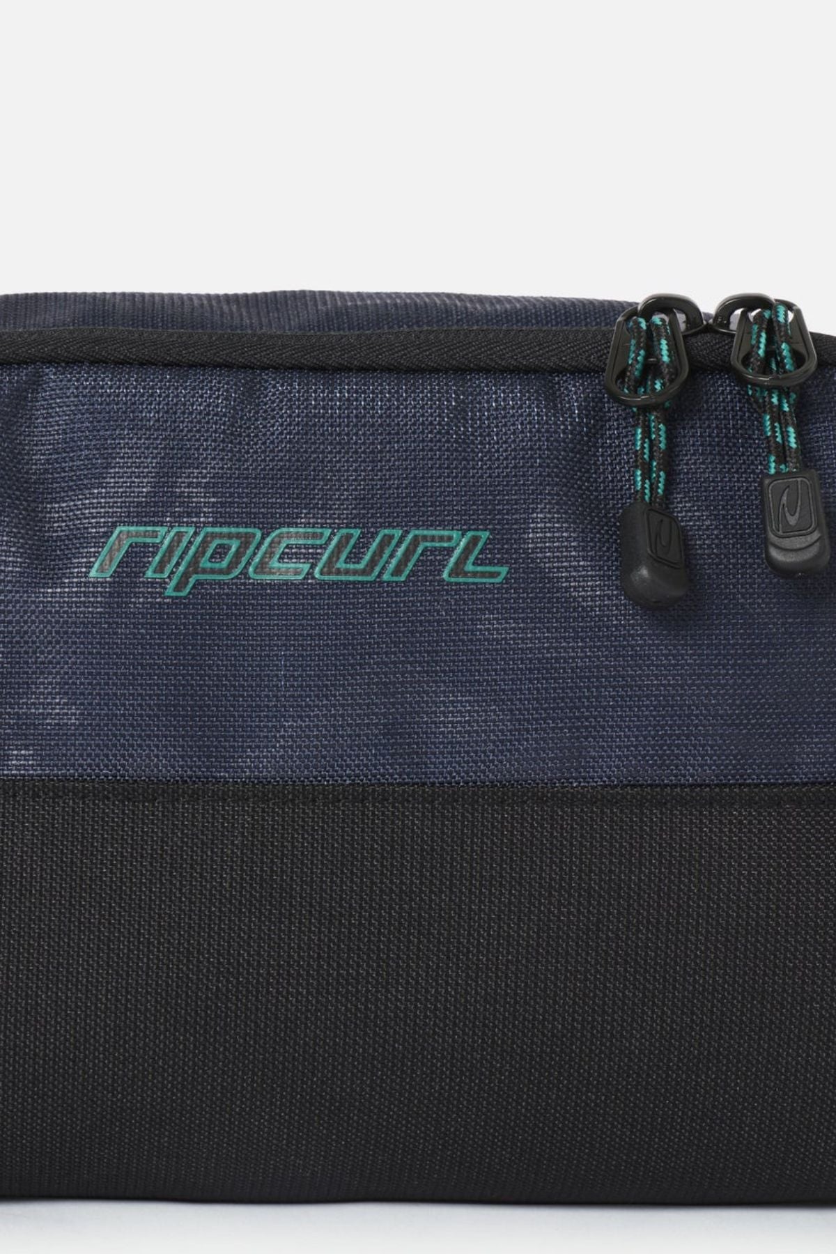 Rip Curl Archive Groom Toiletry Bag in navy blue and black with a teal logo and two zippered compartments, serving as a functional travel organiser.