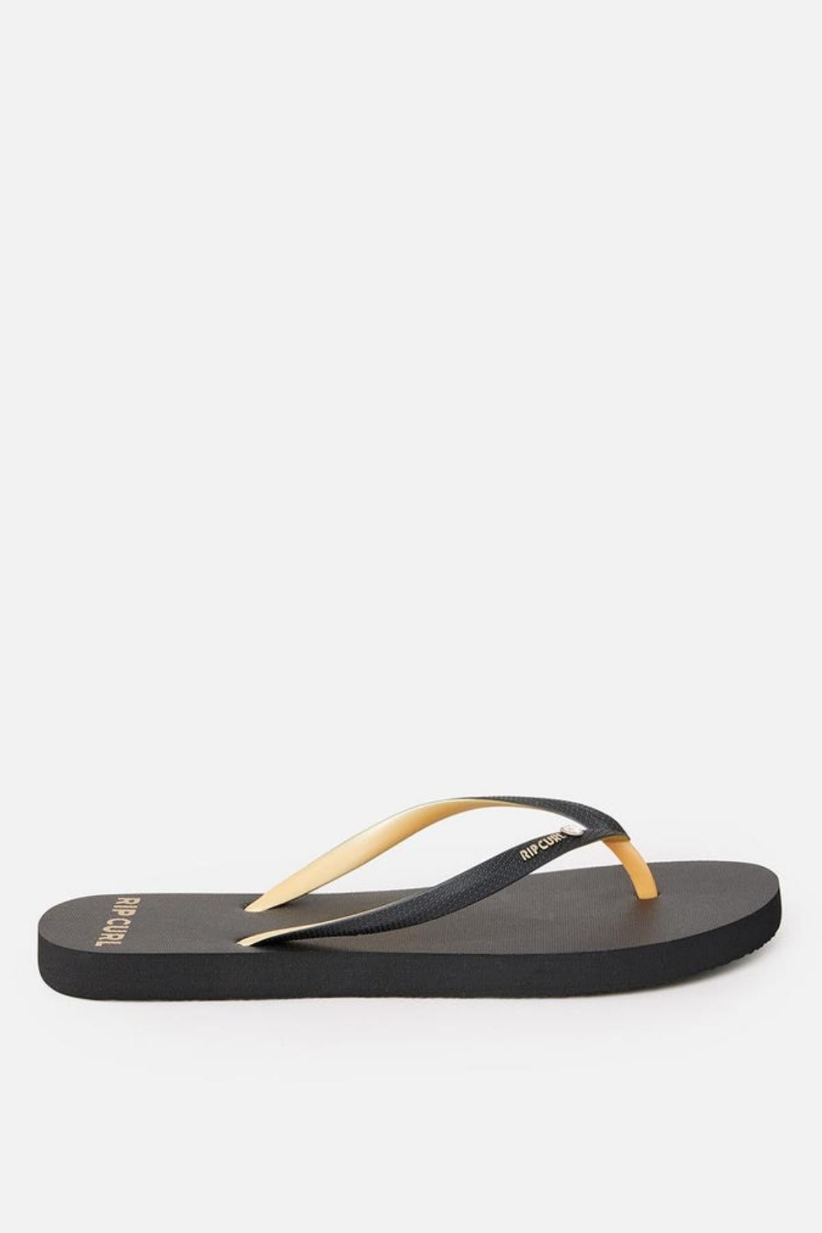 A single Rip Curl Premium Surf Bloom flip-flop sandal, featuring a flat sole and delicate yellow and black straps, is displayed against a plain white background. The word "Brazil" is visible on the heel area.