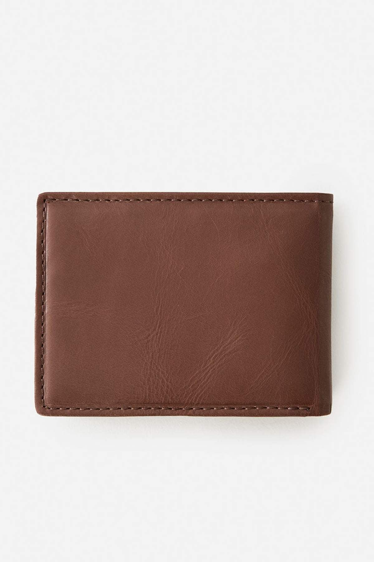 The Rip Curl Raw Energy RFID Slim Wallet, made of closed brown buff cow leather with visible stitching, is shown on a light plain background.