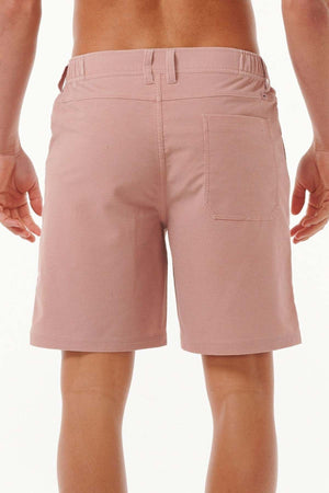 Rear view of a person wearing the Rip Curl Saltwater Culture Cord Boardwalk Short in light pink, showcasing Rip Curl's quick-dry technology. These stylish shorts include a single back pocket on the right side, set against a plain white background.