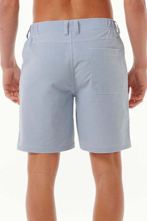 Back view of a person wearing the Rip Curl Saltwater Culture Cord Boardwalk Short in light blue, perfect for a beach adventure. These shorts feature an elastic waistband and a patch pocket on the right side. The quick-dry technology makes them ideal for any outing, as they stand against a plain white background.