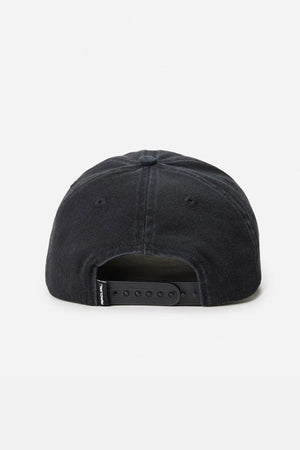 The Rip Curl Searchers SB Cap features an unstructured black cotton twill design, a plastic adjustable strap at the back, and a small fabric tag near the closure.