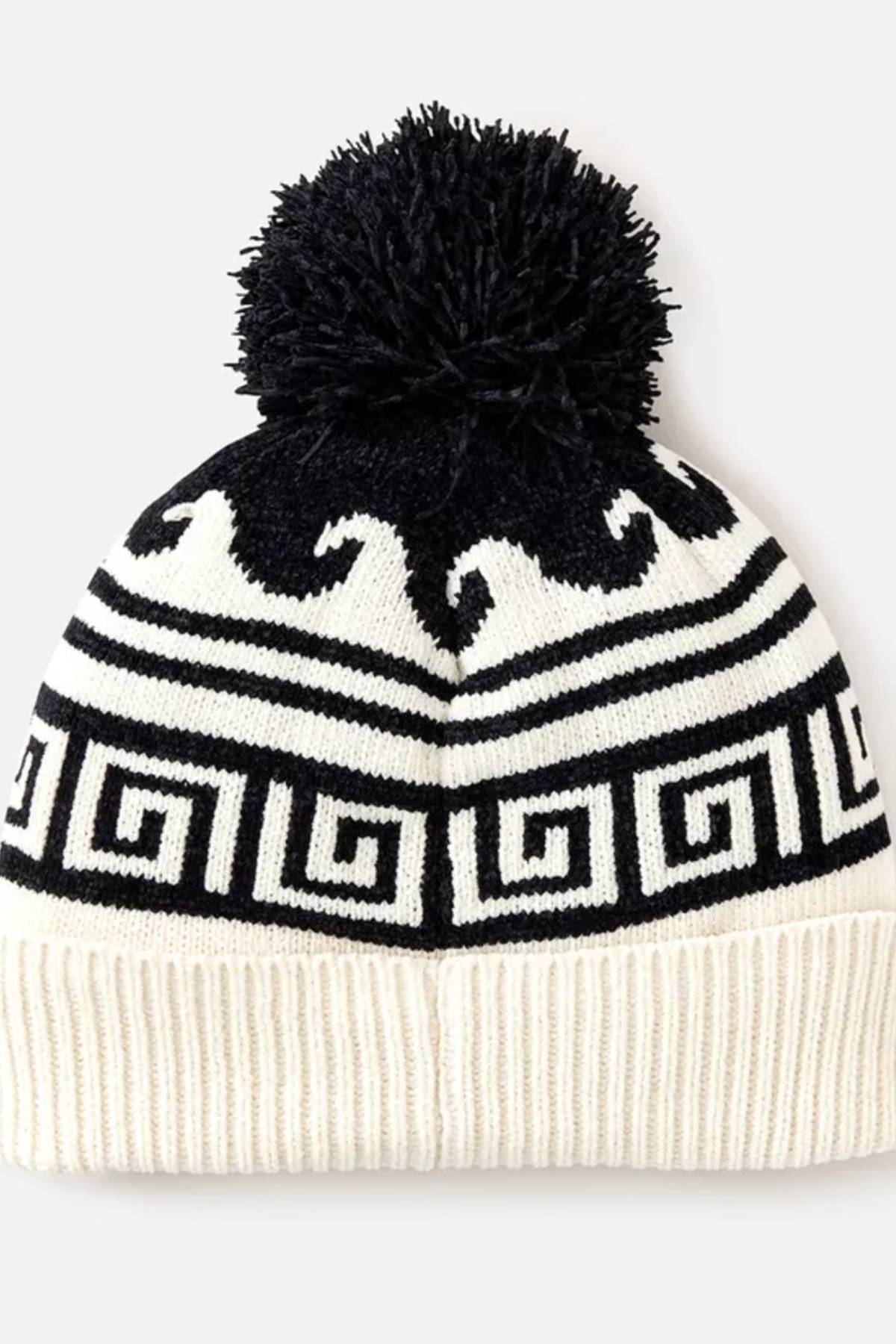 The Rip Curl Soleil Regular Pom Pom Beanie is a black and white knit beanie with a large black pom-pom, Greek key and wave intarsia patterns, and a ribbed white fold-over brim.