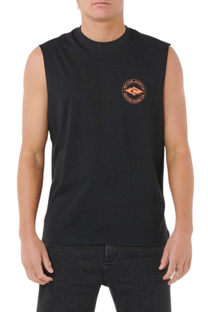 A person wearing a sleeveless black Rip Curl Staple Muscle shirt with a small round orange and black logo on the left chest, paired with black jeans, stands against a white background.