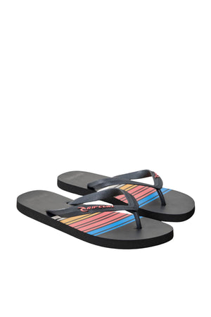 The Rip Curl Surf Revival Bloom Thongs feature black ergonomic rubber straps with a red and white logo, plus a premium EVA footbed decorated with multicolored diagonal stripes in red, yellow, and blue.