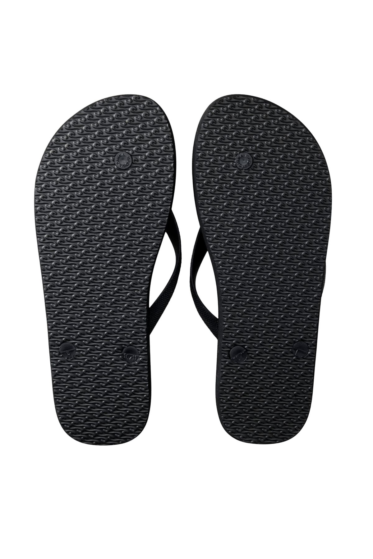 The Rip Curl Surf Revival Bloom Thongs are shown with black ergonomic rubber straps, textured soles, and a premium EVA footbed, all displayed against a clean white background.