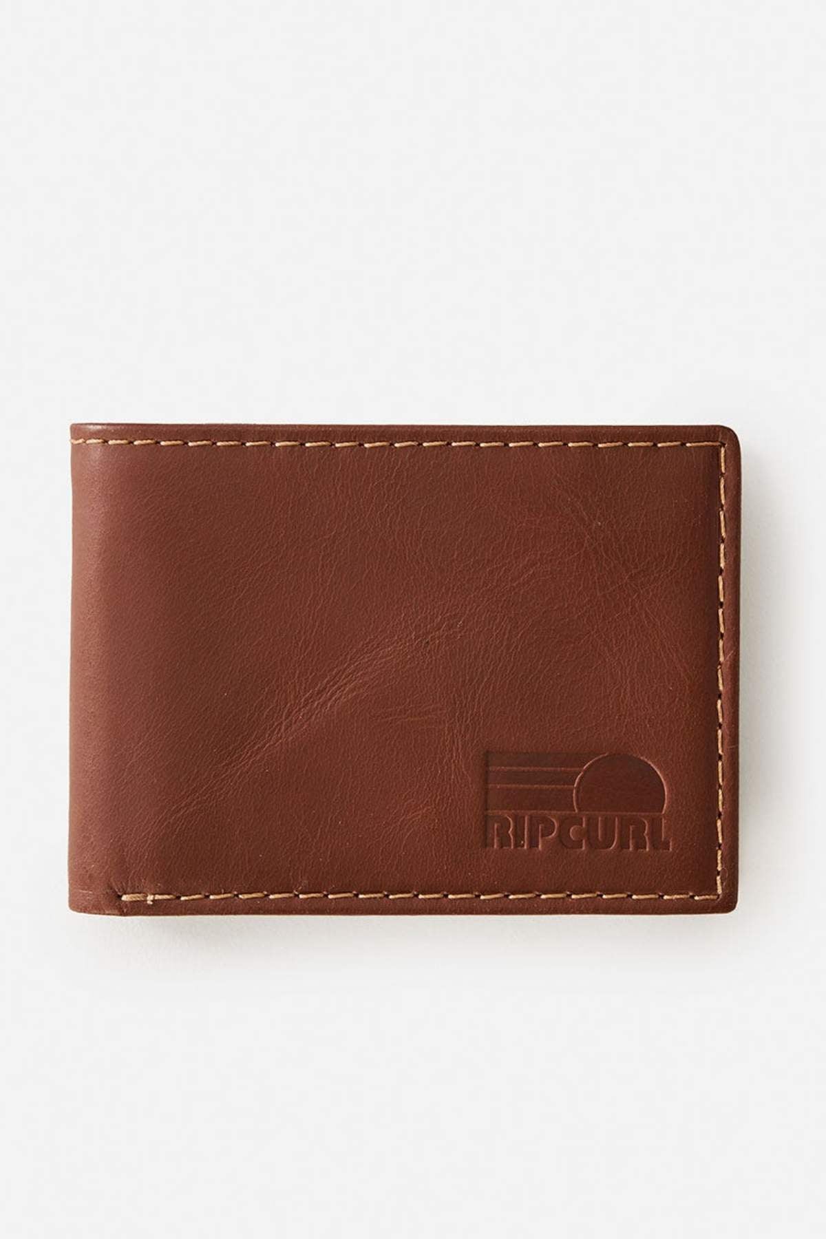 The Rip Curl Surf Revival RFID All Day Wallet is a brown leather wallet with visible stitching, RFID protection to prevent digital theft, and an embossed Rip Curl logo in the bottom right corner, shown on a plain white background.