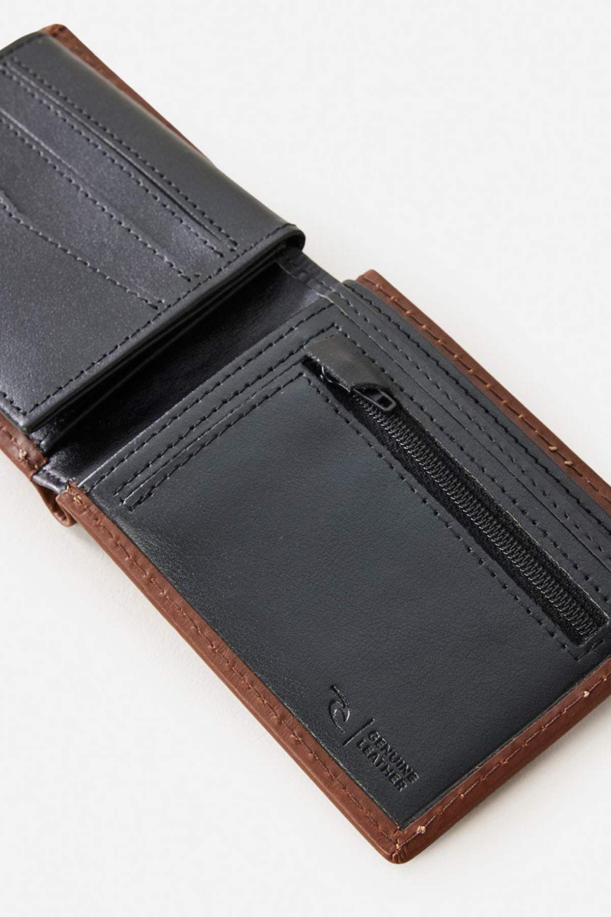 The Rip Curl Surf Revival RFID All Day Wallet is open, displaying multiple card slots, RFID protection against digital theft, a zippered coin pocket, and visible stitching that showcases its quality craftsmanship.