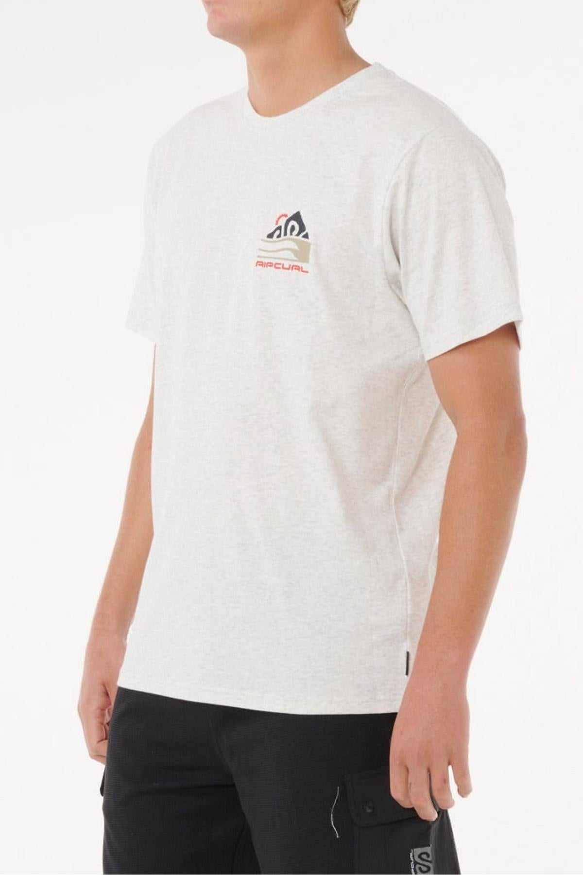 A person wears the Rip Curl Vaporcool Search Range Tee in light gray with a small chest logo and black pants, standing against a plain white background. This quick-drying, short-sleeve shirt offers all-day comfort.